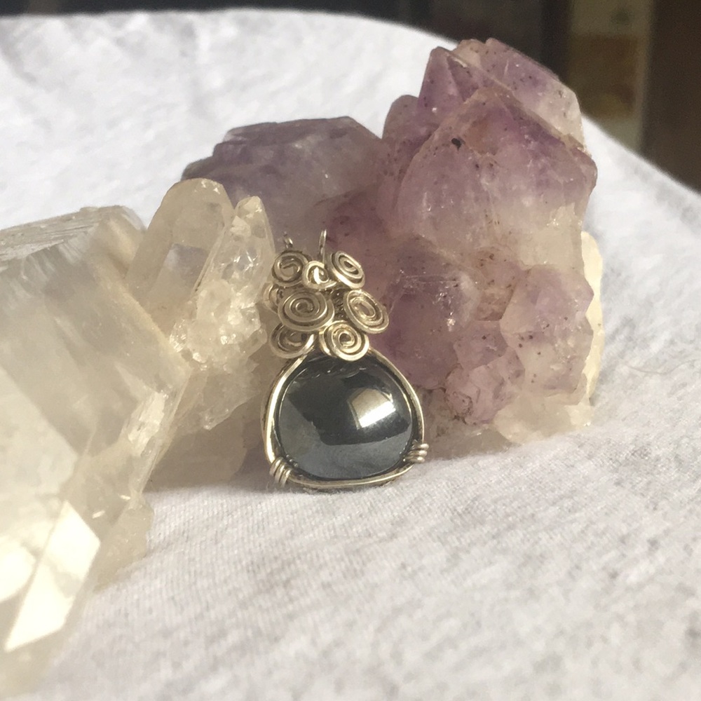 Handmade metallic pendant with silver accent